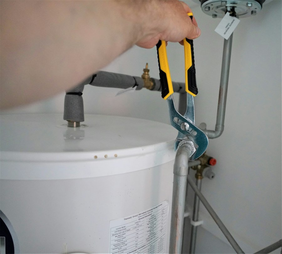 Pine Rooter technician servicing a well pump pipe fitting in the Bothell area, WA